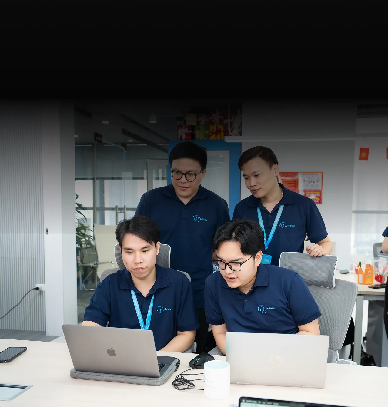 NSC senior engineers collaborating in a modern office